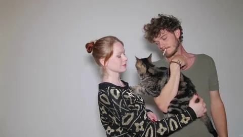 Models playing with cat during photo session 스톡 동영상 73539756