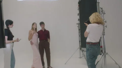 Models pose and smile during creative photoshoot session in studio setting Stock Footage 319926313