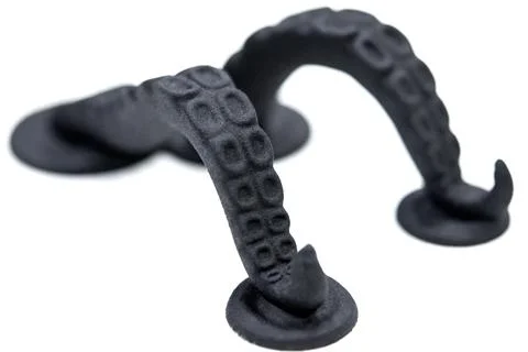 Models printed on 3D printer. Black objects printed on 3D printer made plastic Stock Photos