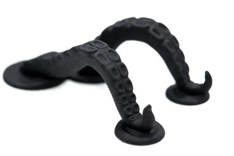 Models printed on 3D printer. Black objects printed on 3D printer made plastic Stock Photos