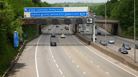 Moderate Traffic under Heathrow road sign on the famous M25 Motorway / London Stock Footage 111583735