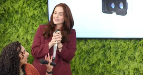 Moderator raising mic and offering to presenter, presenter accepting and Stock Footage 340268121