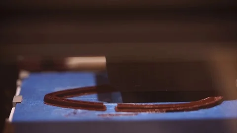 Modern 3D printer applying ABS plastic on surface and printing figure Stock Footage 78669520