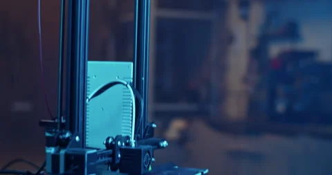 Modern 3D printer creating detail in dark room with neon illumination Video stock 259389240