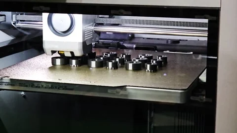 Modern 3D Printer Manufacturing Small Black Plastic Precision Parts on Plate Stockbeeldmateriaal 337021007