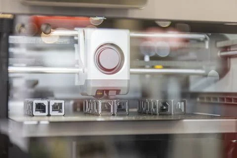 Modern 3D printer precision in action, focused on extruder head depositing .. Stock Photos