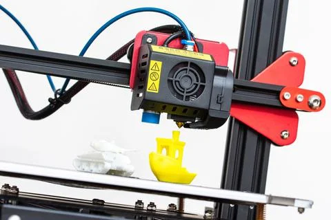 Modern 3D printer printerhead with hotend and fan. Little plastic FDM ship model Stock Photos