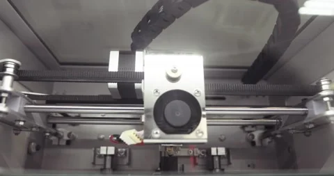 Modern 3d printer printing black plastic object or detail, closeup top view. Stock Footage 142775047