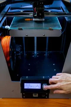 Modern 3D printer printing figure close-up macro 3d printer prints with orang Stock Photos