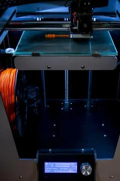 Modern 3D printer printing figure close-up macro 3d printer prints with orang Stock Photos
