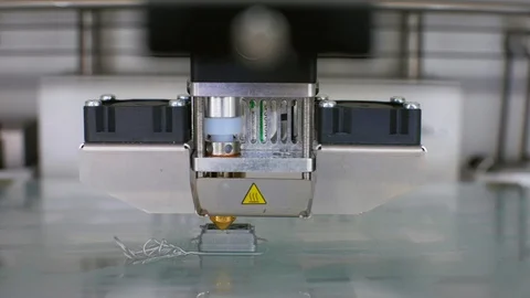 Modern 3D printer printing an object from the hot molten Stock Footage 107338951