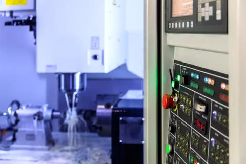 A modern 4-axis cnc vertical milling machine working with water cooling, sele Stock Photos