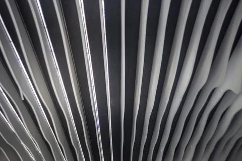 Modern abstract ceiling design with white parallel waves and led illumination Foto stock