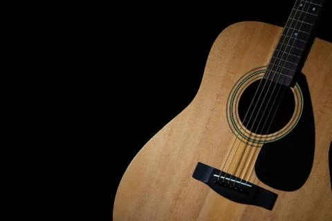 Modern acoustic guitar on black background Stock Photos