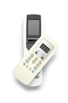 Modern air conditioner remote controls isolated on white background, top view Stock Photos