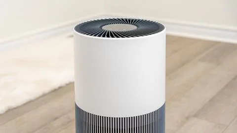 Modern air filter device in a bright room, showcasing sleek design and efficient Stock Photos