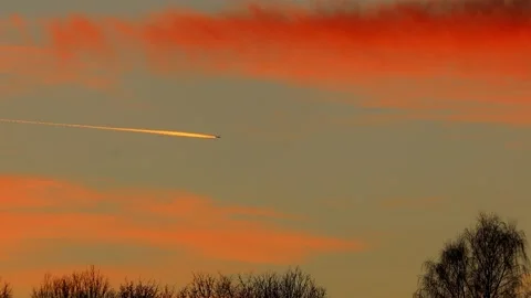 An modern airplane flying through evening clouds 4k 30fps video Stock Footage 297855049