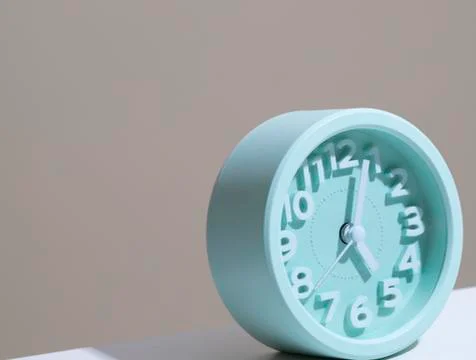 Modern alarm clock stand on the table on white background Stock Photos