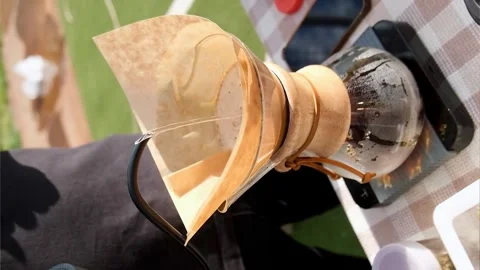 Modern and alternative ways of making coffee outdoor. Barista brews coffee using Stock Footage 244381635