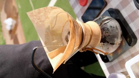 Modern and alternative ways of making coffee outdoor. Barista brews coffee using Stock Footage 244596682