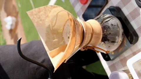 Modern and alternative ways of making coffee outdoor. Barista brews coffee using Stock Footage 244596705