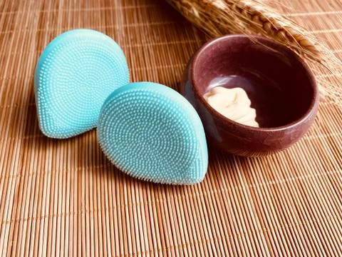 Modern and tiny cleansing silicone brush on bamboo with authentic look Stock Photos