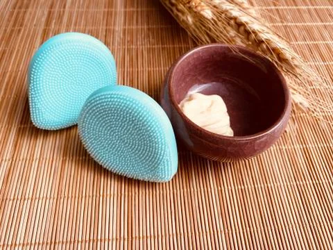 Modern and tiny cleansing silicone brush on bamboo with authentic look Stock Photos