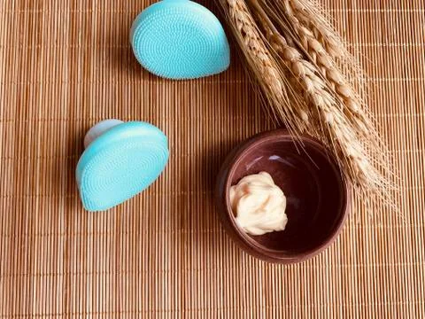 Modern and tiny cleansing silicone brush on bamboo with authentic look Stock Photos