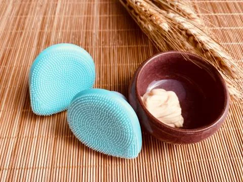 Modern and tiny cleansing silicone brush on bamboo with authentic look Stock Photos