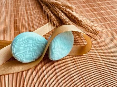 Modern and tiny cleansing silicone brush on bamboo with authentic look Stock Photos