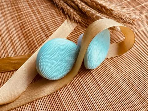 Modern and tiny cleansing silicone brush on bamboo with authentic look Stock Photos