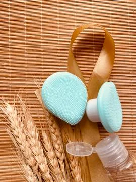 Modern and tiny cleansing silicone brush on bamboo with authentic look Stock Photos