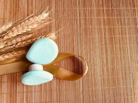 Modern and tiny cleansing silicone brush on bamboo with authentic look Stock Photos