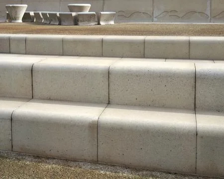 Modern angled outdoor steps with rounded corners in textured grey and brown Stock Photos