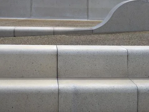 Modern angled outdoor steps with rounded corners int textured grey and brown Stock Photos