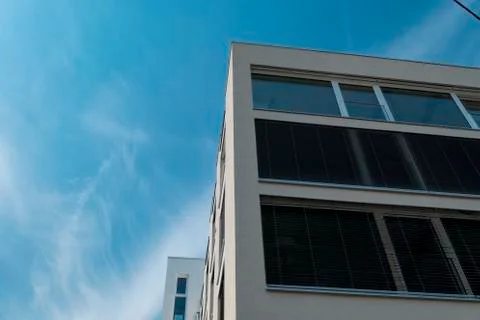 Modern angular house facade with large windows and blue sky Stock Photos
