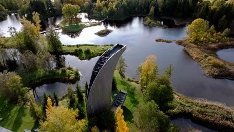 Modern Angular Watch Tower Amidst Autumnal Water Bodies and Islands Stock Footage 296565324