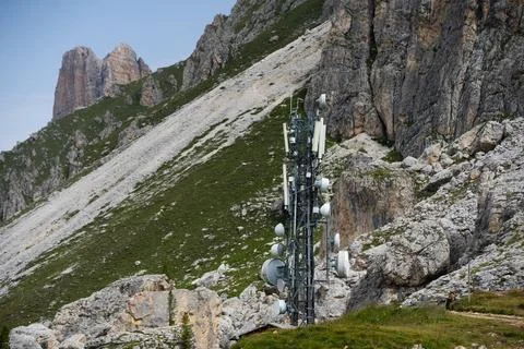 Modern antenna array on a remote mountaintop, connecting a vast mountain an.. Stock Photos