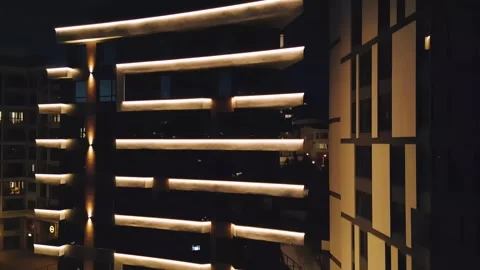 Modern Apartment Building Facade with LED Balcony Lighting at Night Stock Footage 345733146