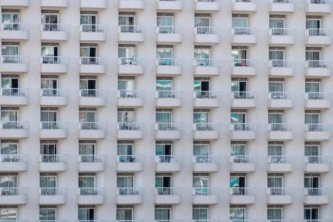 Modern apartment building facade with repeating balconies pattern Stock Photos