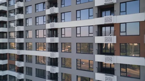 Modern apartment building facade with white balconies and glass reflections Stock Footage 346233338