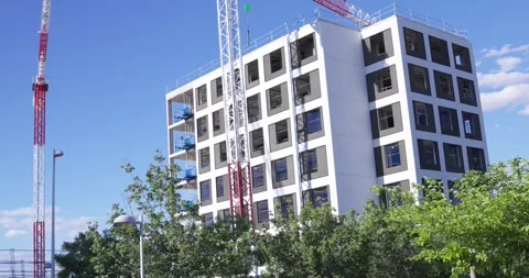 Modern apartment building under construction with tower cranes in Madrid Stockbeeldmateriaal 336301135