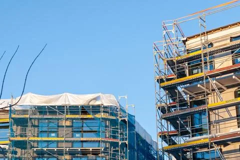 Modern apartment complex construction with scaffolding Stock Photos