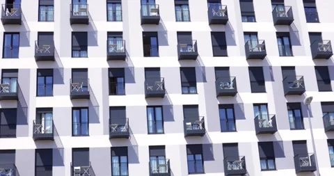 Modern apartment facade with repeating balconies and window pattern Stock Footage 336582435