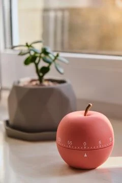 Modern apple shaped timer next to windows Stock-Fotos