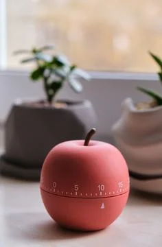 Modern apple shaped timer next to windows Stock-Fotos