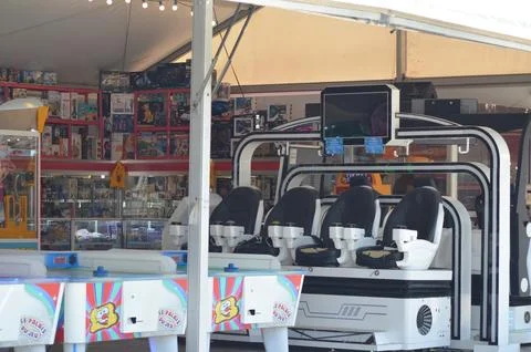 Modern arcade gaming setup featuring sleek white gaming chairs and vibrant .. Stock Photos