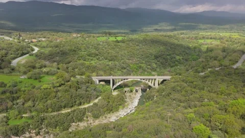 Modern Arch Bridge in Green Mountain Valley, Peloponnese Stock Footage 337087109