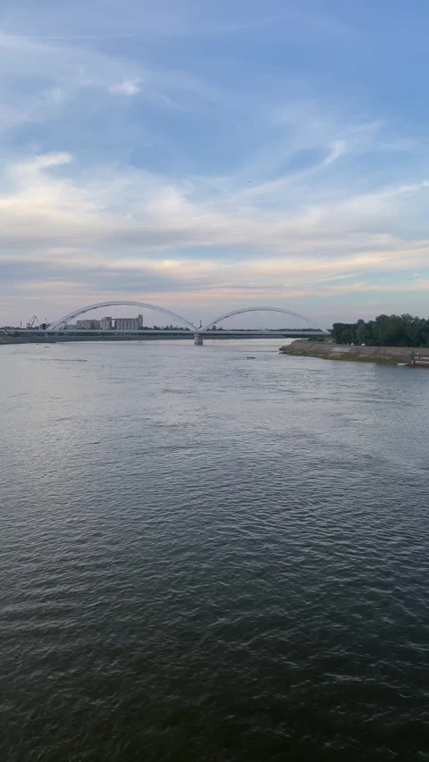 Modern arched bridge over Danube River, Novi Sad, Serbia at sunset Stock Footage 339480153