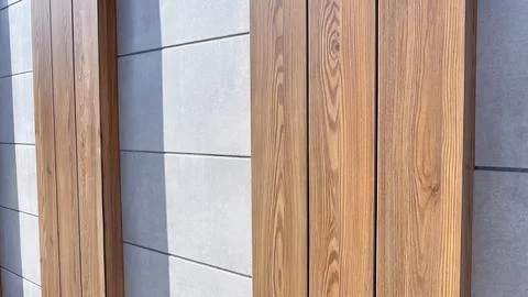 Modern architectural background featuring natural wood planks and grey conc.. Stock Photos